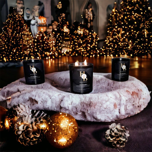 Christmas Home Decorations, Scented Candles in a Luxury home laying on a fluffy blanket. Cosy Winter Decor
