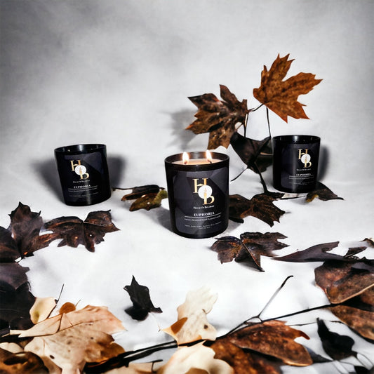 Scented Soy Candles on a white cloudy background with autumn leaves, wellbeing candles