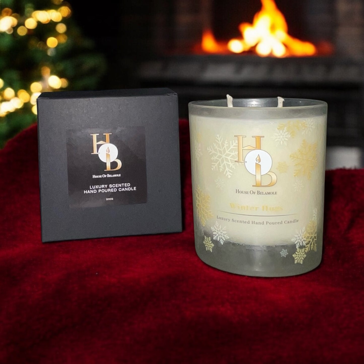 Unique Scented Christmas Candle on a red blanket next to a packaging box, behind is a fireplace and a christmas tree.