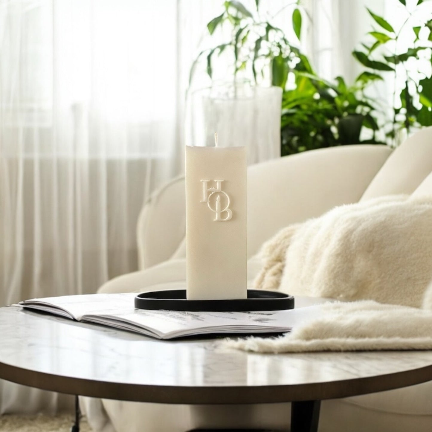 Coffee table decor featuring a sculptural soy candle and neutral home fragrance accessories.