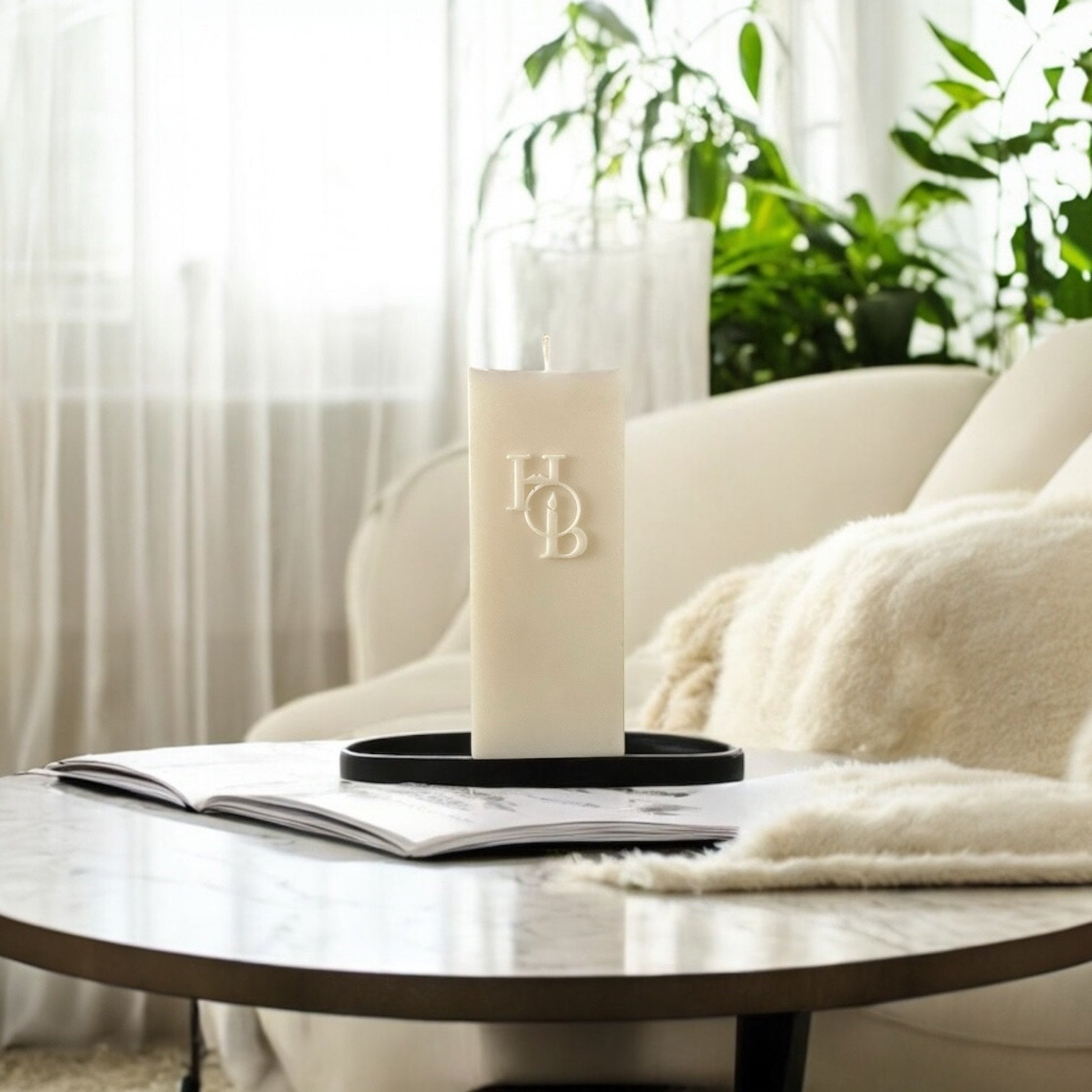 Coffee table decor featuring a sculptural soy candle and neutral home fragrance accessories.
