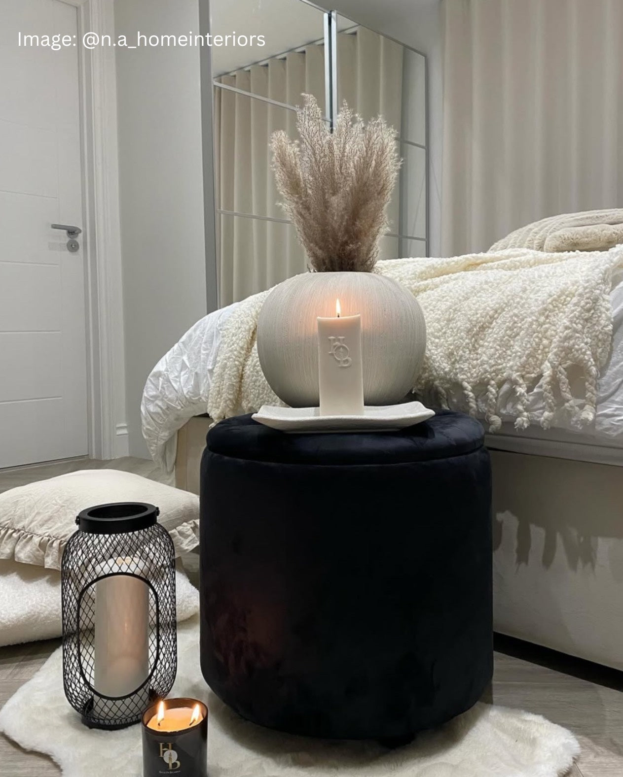 Euphoria scented pillar candle with notes of cherry and rose styled in a bright, uplifting room.
