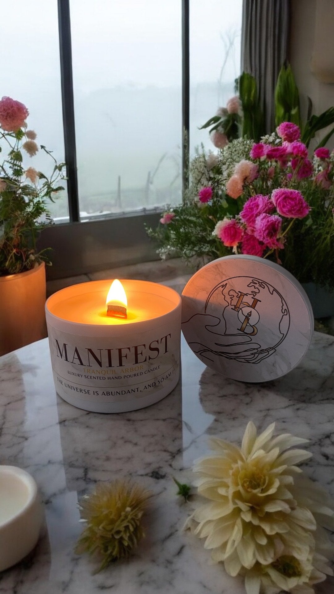 Lit Tranquil Arbor manifestation candle styled in a serene home interior, blending floral woody oudh fragrance with a calming glow for relaxing, intention-led spaces.