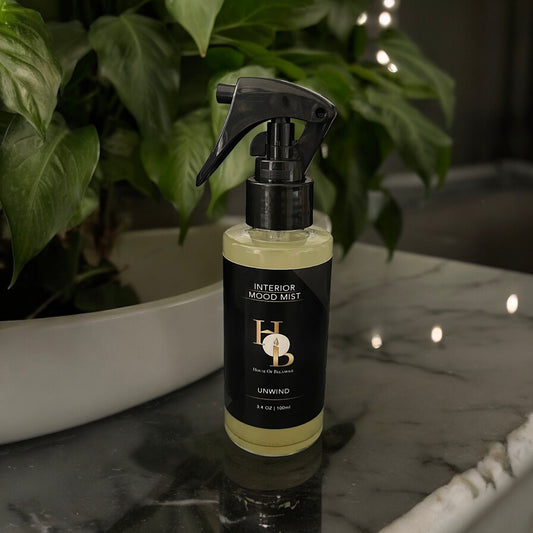 Unwind interior mist styled in a luxury home, offering a soft, calming floral woody scent to enhance relaxation and well-being through elegant home fragrance.