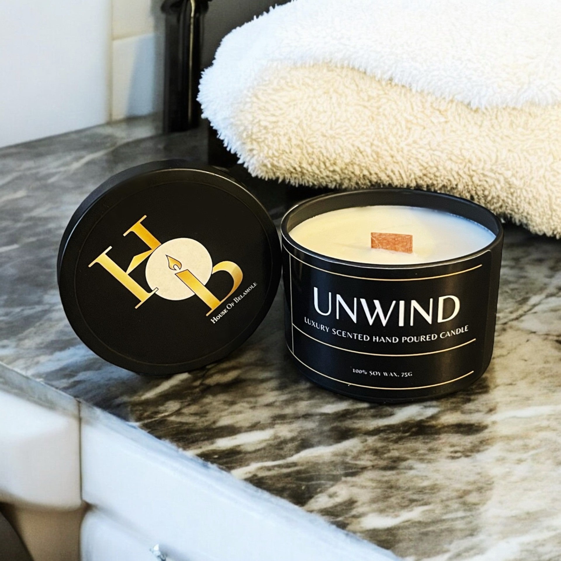 Unwind woodwick candle styled in an elegant luxury interior, delivering a calming floral woody scent and comforting ambiance for relaxing home fragrance.