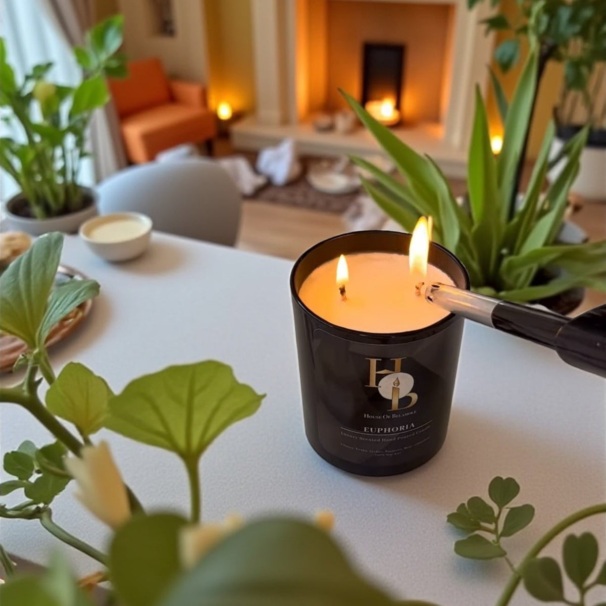 A scented soy candle in a glass jar with a being lit by a black lighter on a white table, surrounded by green houseplants in a cozy, warm-toned living room setting