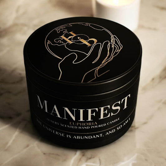 Manifest Candle on a cream marble table