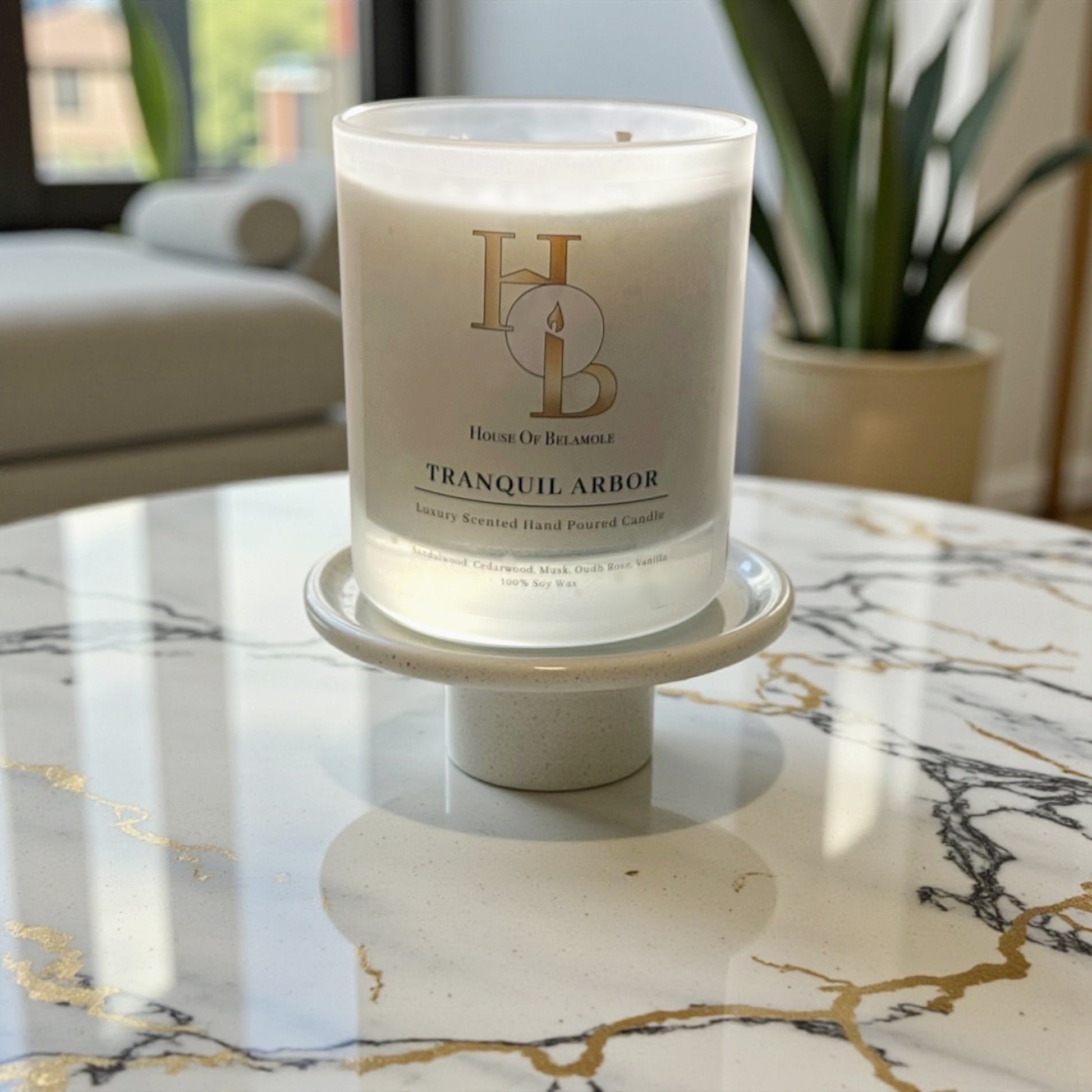 
Tranquil Arbor scented soy candle with calming floral woody notes of oudh rose, sandalwood, and cedarwood, crafted for grounding home fragrance and elegant interior decor.